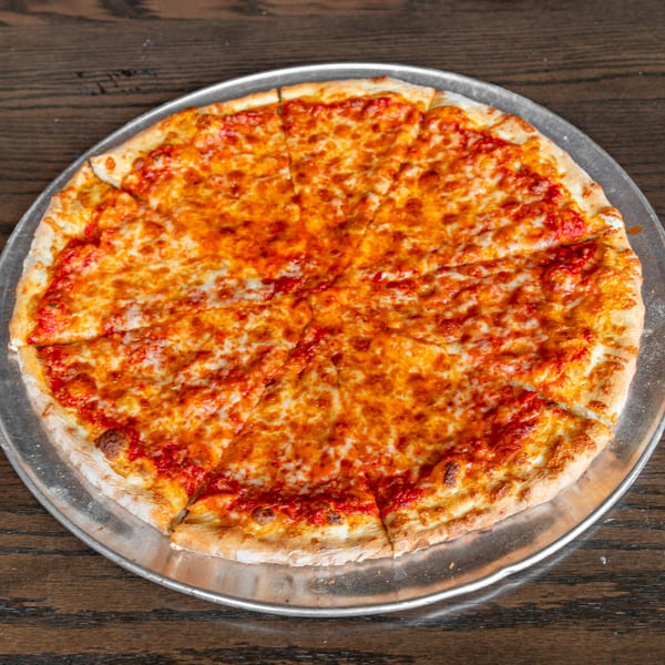 A whole cheese pizza, sliced into eight pieces, on a metal tray on a wooden table.